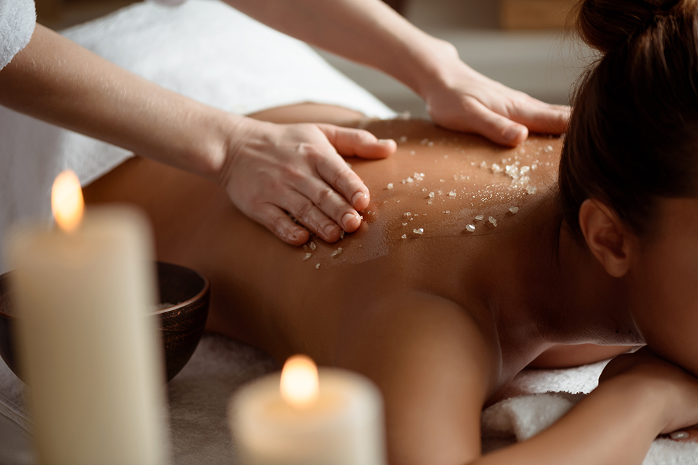 Young beautiful brunette girl relaxing in spa salon. Copy space.